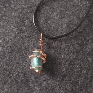 Quantum Quattro crystal wrapped in bare copper with leather cord approx 18 "